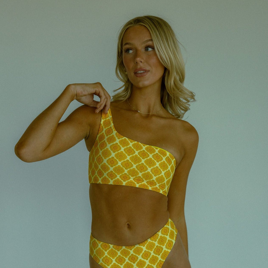 Yellow patterned seamless bikini top with one shoulder design.